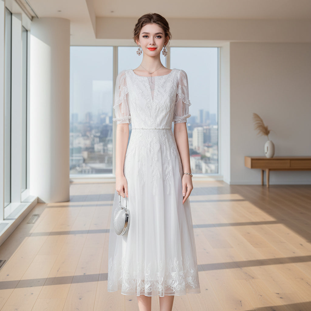 Woman wearing a white lace dress against a gray background