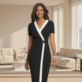 Black dress with a white stripe worn by a model on a white background