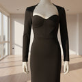 Black dress on a mannequin against a white background